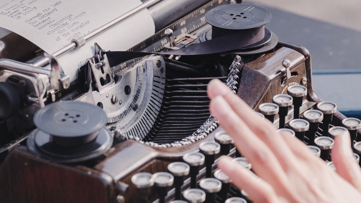 Someone typing a poem on a typewriter.