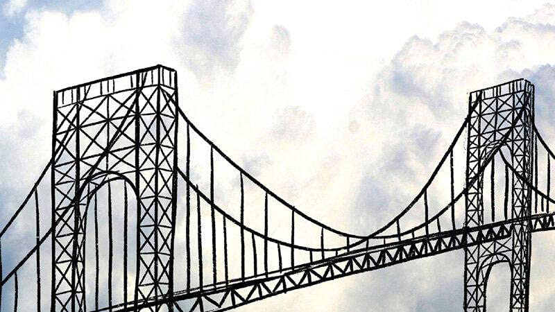 A black bridge with a cloudy sky in the background.