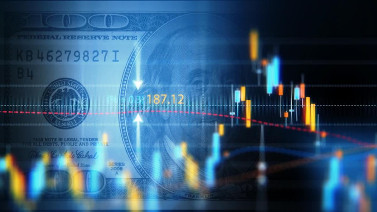 U.S. currency with stock graphics overlaid.