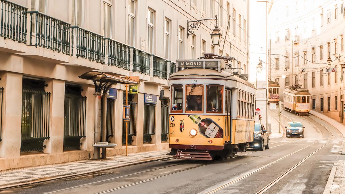 A streetcar going down a road in Portugal.