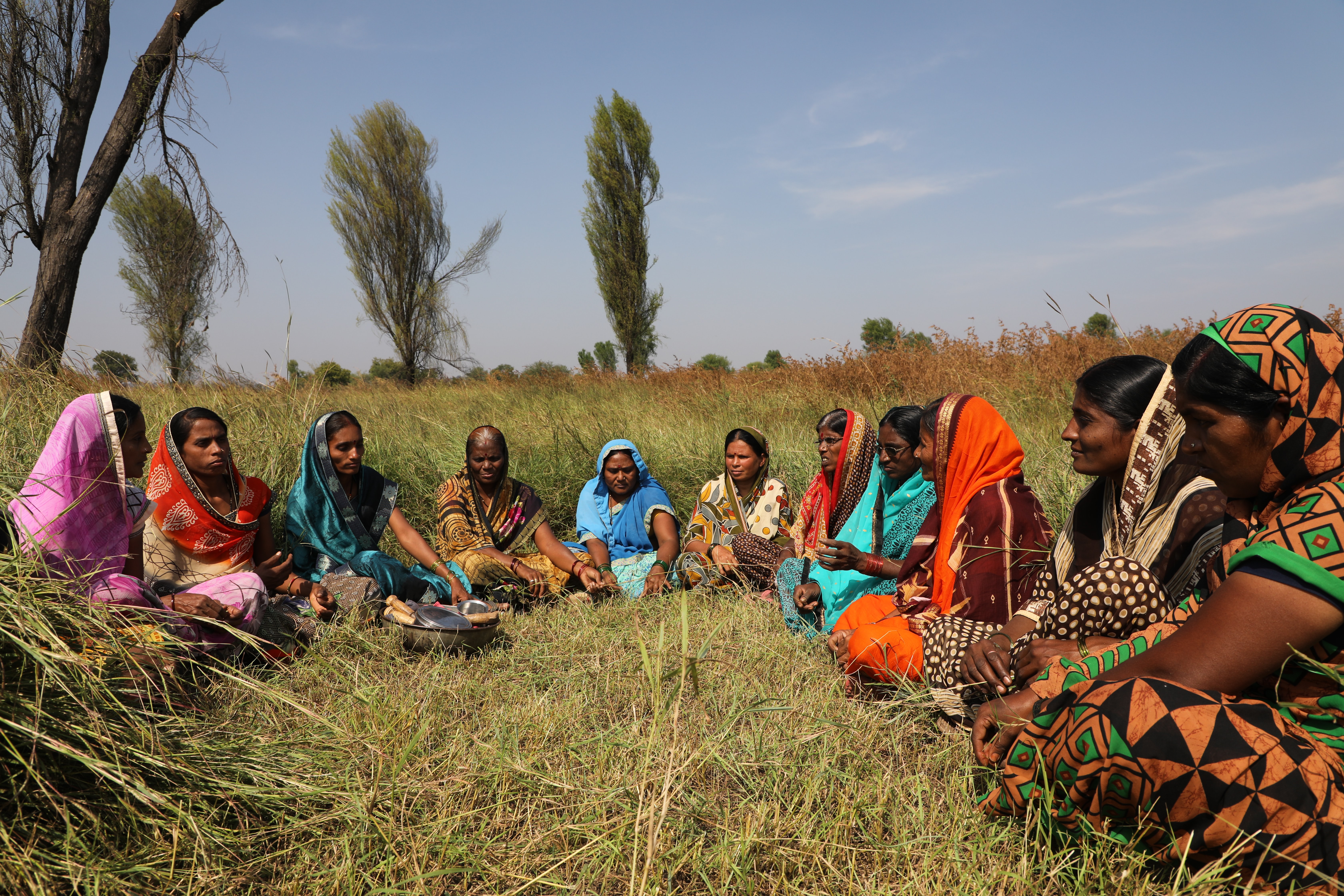 Women seated in colorful clothing in rural India