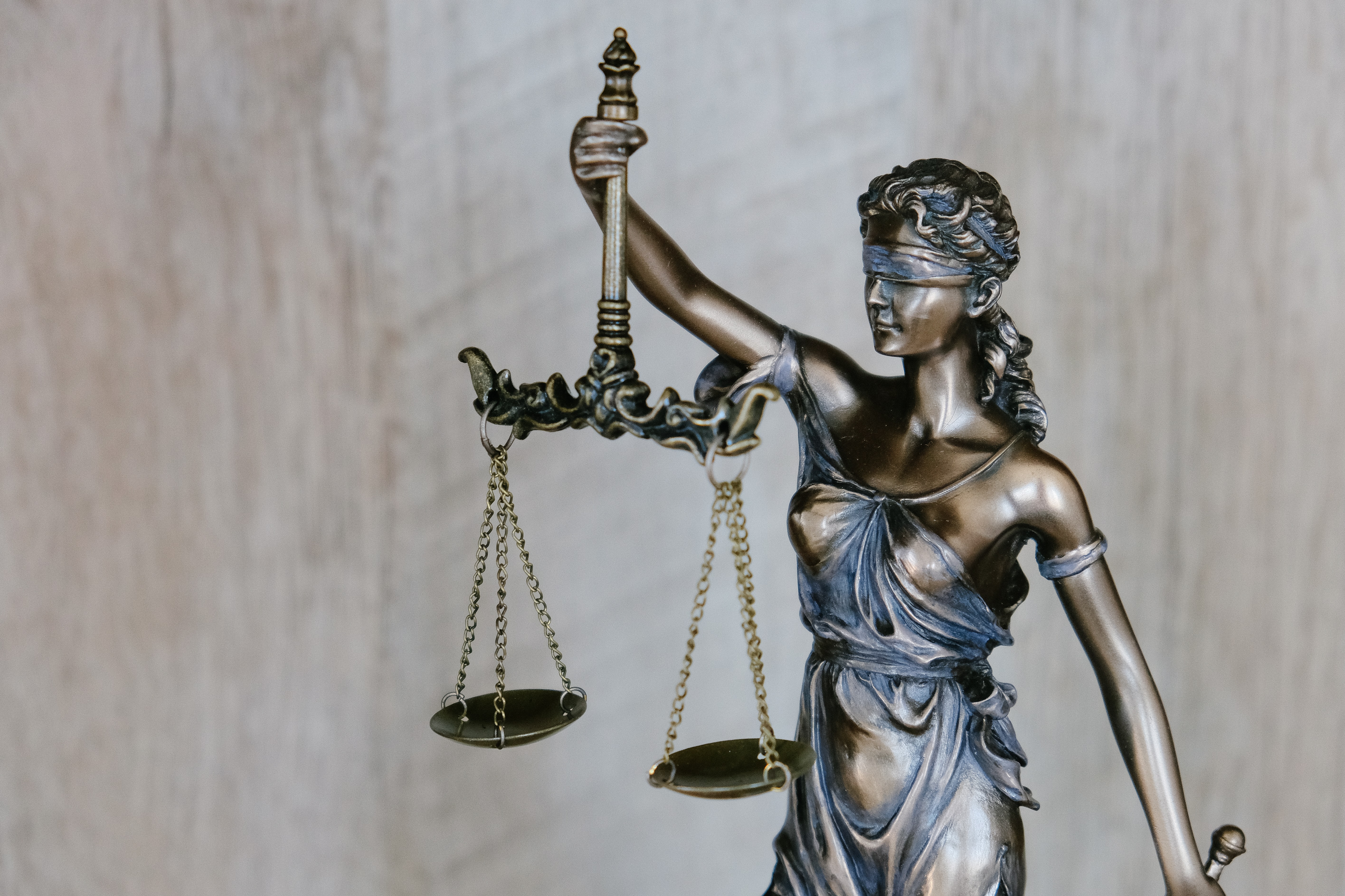 Bronze statue of woman with law scales
