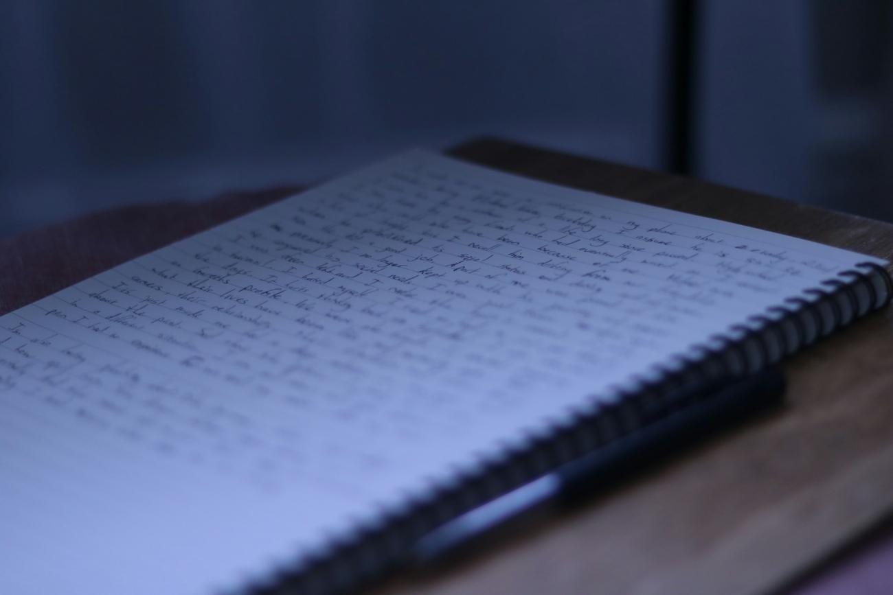 Close-up of a journal turned open to a page of writing.